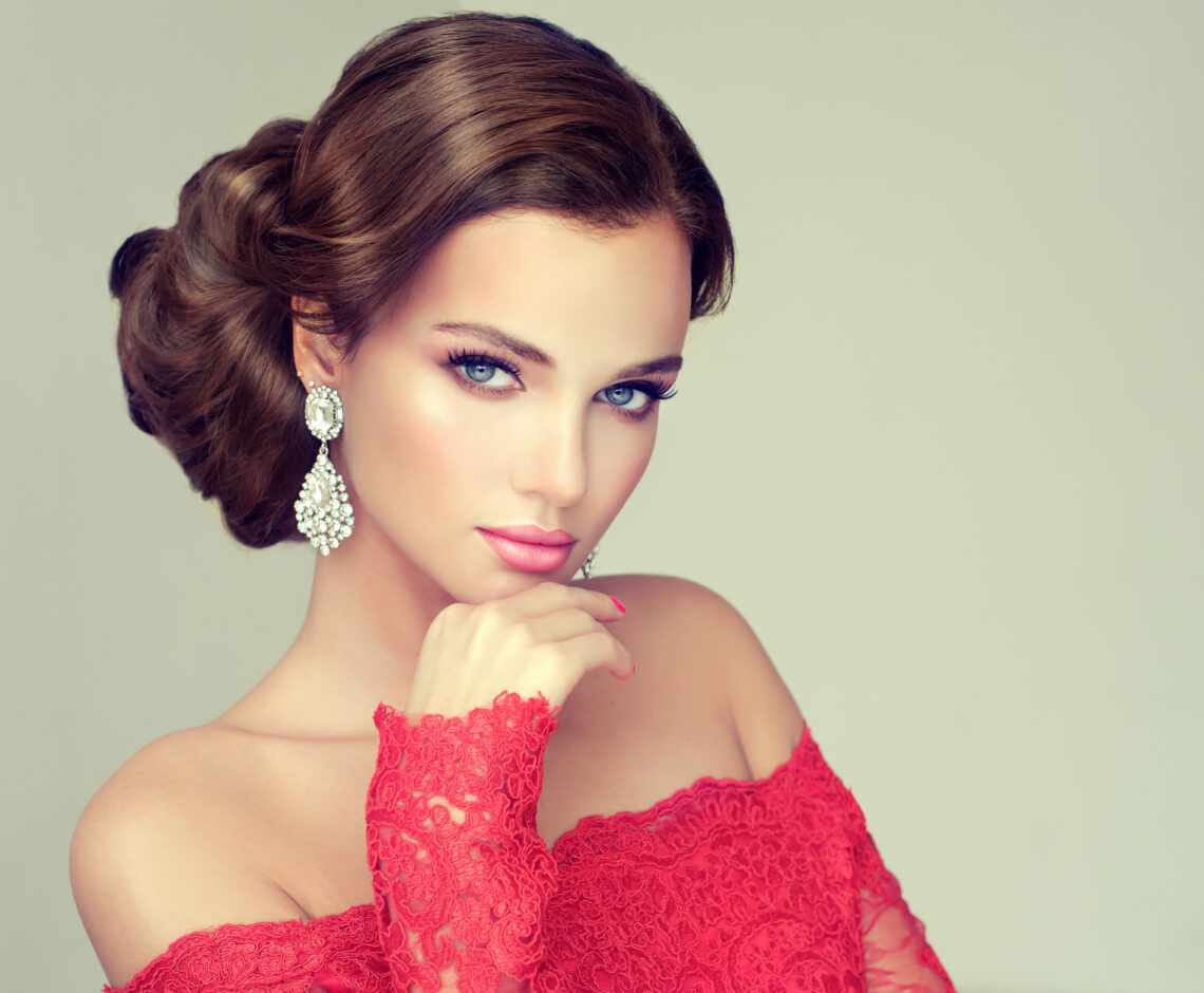Beautiful model with elegant hairstyle . Beautiful woman with fashion wedding hairstyle with trend makeup .